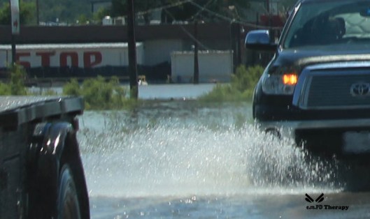 Truck cruising through flood area