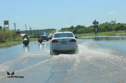 Bikers navigating flood waters